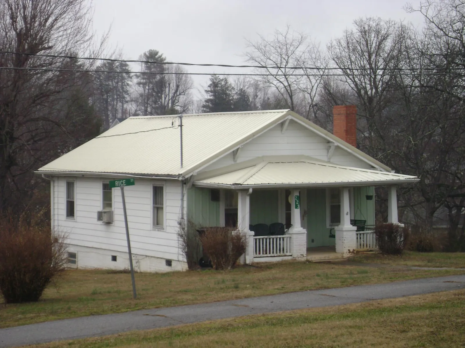 White metal roof on a craftsman bungalow at a street corner in Bullock